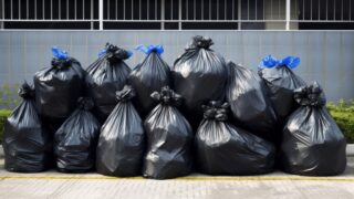 pngtree-pile-of-black-garbage-bags-image_2559472